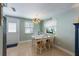 Inviting dining area with a white table, seating for four, and natural light from the windows at 214 Palm Ave, Anna Maria, FL 34216