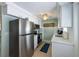Modern kitchen featuring stainless steel appliances, white cabinets, and quartz countertops at 214 Palm Ave, Anna Maria, FL 34216