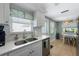 Modern kitchen featuring stainless steel appliances, white cabinets, and quartz countertops at 214 Palm Ave, Anna Maria, FL 34216