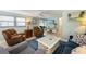 Cozy living room featuring comfortable seating, a TV, and a stylish area rug at 214 Palm Ave, Anna Maria, FL 34216