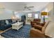 Inviting living room with plush seating, ceiling fan, and a decorative blue patterned rug at 214 Palm Ave, Anna Maria, FL 34216