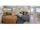 Cozy living room featuring comfortable seating, a TV, and a stylish area rug at 214 Palm Ave, Anna Maria, FL 34216