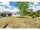 Spacious backyard surrounded by mature trees offering shade and privacy at 22209 Breezeswept Ave, Port Charlotte, FL 33952
