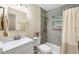 Bright bathroom with modern gray tile, shower and tub combination, and neutral color palette at 22209 Breezeswept Ave, Port Charlotte, FL 33952