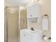 Cozy bathroom featuring a corner shower stall, vanity with storage, and bright lighting at 22209 Breezeswept Ave, Port Charlotte, FL 33952