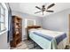 Bright bedroom with a large window, a ceiling fan, and a stylish bookshelf at 22209 Breezeswept Ave, Port Charlotte, FL 33952