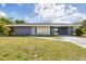 Charming single-story home with stone accents and a well-maintained lawn at 22209 Breezeswept Ave, Port Charlotte, FL 33952