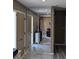 Hallway with mirrored closet doors, tan walls, and tiled floors at 22209 Breezeswept Ave, Port Charlotte, FL 33952