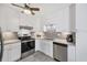 Bright kitchen features gray backsplash, stainless appliances, modern fixtures, and gray tile floors at 22209 Breezeswept Ave, Port Charlotte, FL 33952