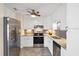 Modern kitchen with stainless steel appliances, white cabinets, and gray backsplash at 22209 Breezeswept Ave, Port Charlotte, FL 33952