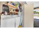 Functional laundry area with washer, dryer, storage shelves, and access to the exterior at 22209 Breezeswept Ave, Port Charlotte, FL 33952