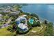 Breathtaking aerial view showcasing the waterfront estate, pool, manicured grounds, and serene bay views at 319 Compass Point Dr # 201, Bradenton, FL 34209
