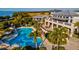 An aerial view of the community pool, clubhouse, and lush landscaping at 319 Compass Point Dr # 201, Bradenton, FL 34209