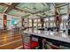 Modern bar and lounge area with a counter, seating, tv, nautical decor, and outdoor views at 319 Compass Point Dr # 201, Bradenton, FL 34209
