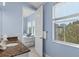 Bathroom with granite countertop vanity, leading to a bedroom with 2 beds and a sunlit window at 319 Compass Point Dr # 201, Bradenton, FL 34209