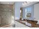 Bathroom features granite countertop and large shower with glass doors at 319 Compass Point Dr # 201, Bradenton, FL 34209