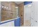 Bathroom features a tiled shower with glass enclosure and a view into the walk-in closet at 319 Compass Point Dr # 201, Bradenton, FL 34209