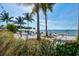 A sandy beach with lounge chairs and a hammock offers a serene spot for relaxation near the tranquil ocean at 319 Compass Point Dr # 201, Bradenton, FL 34209