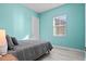 Light-filled bedroom with light blue walls and light wood-look floors at 319 Compass Point Dr # 201, Bradenton, FL 34209