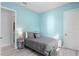 Stylish bedroom with light blue walls and grey queen-sized bed at 319 Compass Point Dr # 201, Bradenton, FL 34209