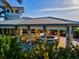 A beautiful outdoor bar and seating area next to a community building and lush landscaping at 319 Compass Point Dr # 201, Bradenton, FL 34209