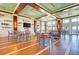 Open dining space with red bar stools and tables, providing ample seating and water views at 319 Compass Point Dr # 201, Bradenton, FL 34209