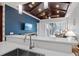 Open-concept kitchen features a breakfast bar, stainless steel faucet, and dark wood ceiling at 319 Compass Point Dr # 201, Bradenton, FL 34209
