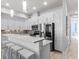 Bright, all-white kitchen with stainless steel appliances, pendant lights, and a breakfast bar at 319 Compass Point Dr # 201, Bradenton, FL 34209