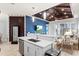 Kitchen island with breakfast bar seating, stainless steel sink, and adjacent living area at 319 Compass Point Dr # 201, Bradenton, FL 34209