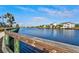 Scenic waterfront view with lush landscaping, palm trees, and picturesque residential buildings in the background at 319 Compass Point Dr # 201, Bradenton, FL 34209