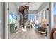 Airy living room with wooden spiral staircase and large windows offering picturesque views at 319 Compass Point Dr # 201, Bradenton, FL 34209