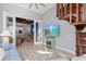 Bright living room with a wooden spiral staircase and a view of the open concept kitchen at 319 Compass Point Dr # 201, Bradenton, FL 34209