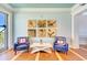 Comfortable lounge space with chairs, coffee table, nautical artwork, and light blue painted walls at 319 Compass Point Dr # 201, Bradenton, FL 34209