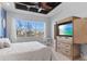 Comfortable main bedroom featuring a decorative ceiling, large windows, and hidden television at 319 Compass Point Dr # 201, Bradenton, FL 34209