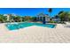 Beautiful community pool area with lounge chairs, a covered seating area, and well-maintained landscaping at 319 Compass Point Dr # 201, Bradenton, FL 34209