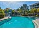 Inviting community pool area with tropical landscaping, perfect for relaxation and socializing at 319 Compass Point Dr # 201, Bradenton, FL 34209