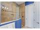 Modern tiled shower with a glass door and custom shelving; adjacent to a white door at 319 Compass Point Dr # 201, Bradenton, FL 34209