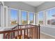Staircase landing with large windows offering scenic views of the surrounding neighborhood at 319 Compass Point Dr # 201, Bradenton, FL 34209