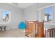 Bright staircase landing with wood railing and a cozy sitting area, illuminated by natural light at 319 Compass Point Dr # 201, Bradenton, FL 34209