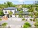 Expansive aerial view showcasing the property's prime location amidst lush greenery and nearby cityscapes at 324 Siesta Dr, Sarasota, FL 34242