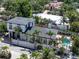 Beautiful aerial shot showing pool, tropical landscaping, and upper-level balcony, with surrounding homes visible at 324 Siesta Dr, Sarasota, FL 34242
