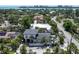 Expansive aerial view of property including surrounding neighborhood, pool, and tropical landscaping at 324 Siesta Dr, Sarasota, FL 34242