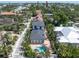 Lovely aerial view of property highlighting the pool, tropical landscaping, and surrounding neighborhood at 324 Siesta Dr, Sarasota, FL 34242