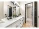 Bathroom featuring double sinks, a stylish mirror, and black hardware at 324 Siesta Dr, Sarasota, FL 34242