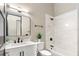 Bright bathroom featuring sleek fixtures, decorative plant, and a combined shower and tub at 324 Siesta Dr, Sarasota, FL 34242