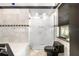 Modern bathroom featuring a frosted glass shower, toilet, and window with wood blinds at 324 Siesta Dr, Sarasota, FL 34242