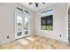 Bright bedroom features travertine floors, transom window and french doors leading to balcony at 324 Siesta Dr, Sarasota, FL 34242
