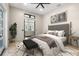 Comfortable bedroom featuring a ceiling fan, two windows and a stylish rug at 324 Siesta Dr, Sarasota, FL 34242