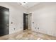 Bright bedroom features travertine floors, neutral paint and modern black doors at 324 Siesta Dr, Sarasota, FL 34242