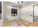 Bedroom features a black trimmed window, transom window, neutral paint and travertine floors at 324 Siesta Dr, Sarasota, FL 34242